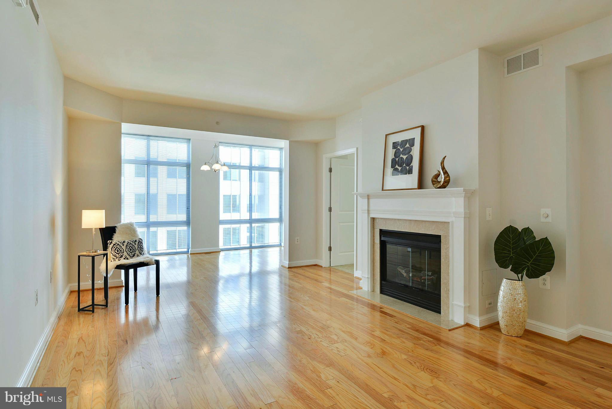 11990 Market Street, Unit 1204 Reston, VA 20190 - Photo 13 of 30 a living room with furniture and a fireplace