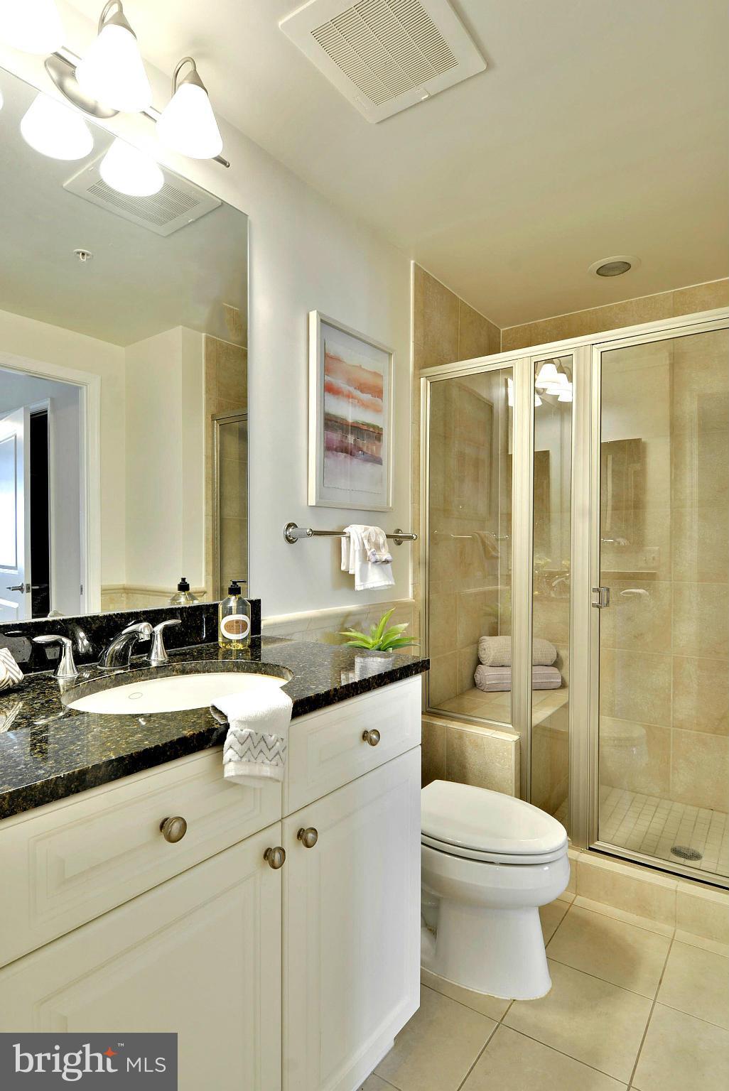11990 Market Street, Unit 1204 Reston, VA 20190 - Photo 16 of 30 a bathroom with a double vanity sink toilet and shower