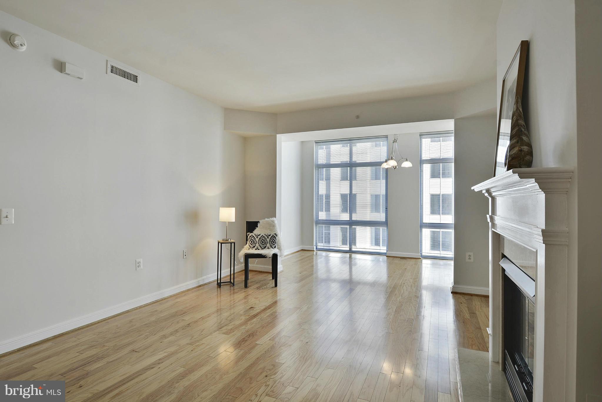 11990 Market Street, Unit 1204 Reston, VA 20190 - Photo 17 of 30 wooden floor in an empty room with a window