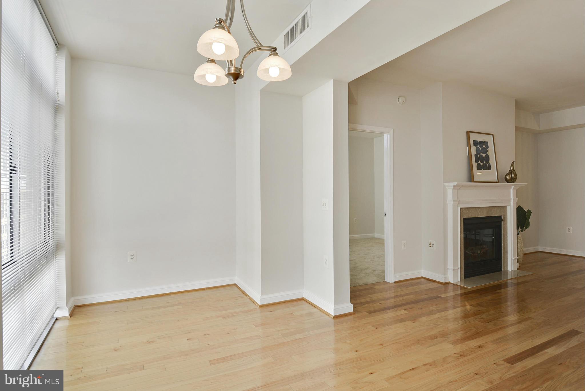 11990 Market Street, Unit 1204 Reston, VA 20190 - Photo 18 of 30 a view of an empty room with wooden floor and a window