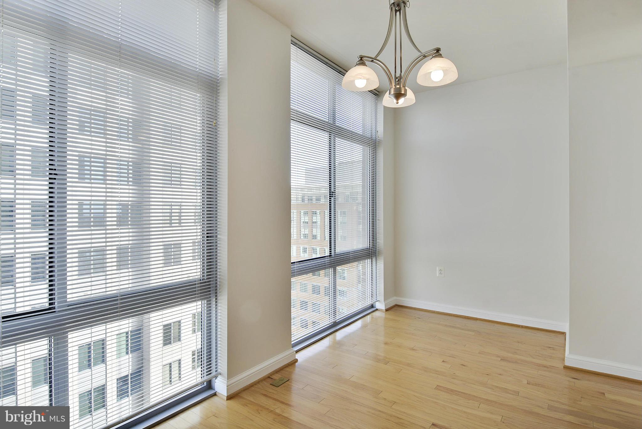 11990 Market Street, Unit 1204 Reston, VA 20190 - Photo 19 of 30 a view of a room with wooden floor and windows