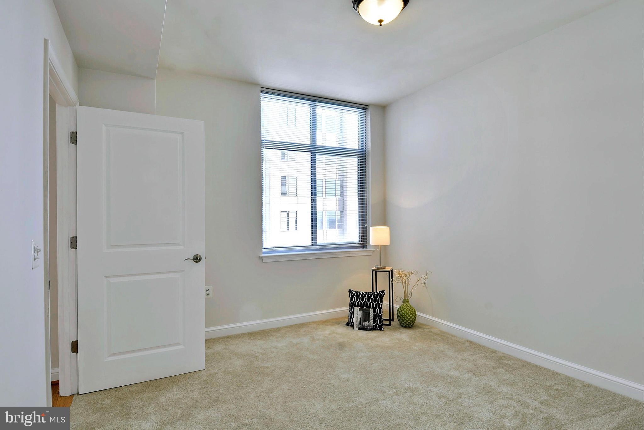 11990 Market Street, Unit 1204 Reston, VA 20190 - Photo 20 of 30 an empty room with windows