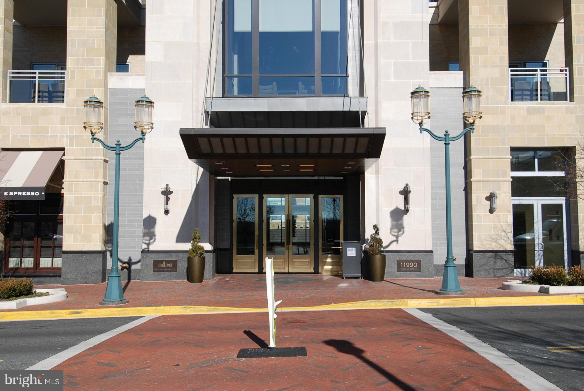11990 Market Street, Unit 1204 Reston, VA 20190 - Photo 3 of 30 a front view of a building with street