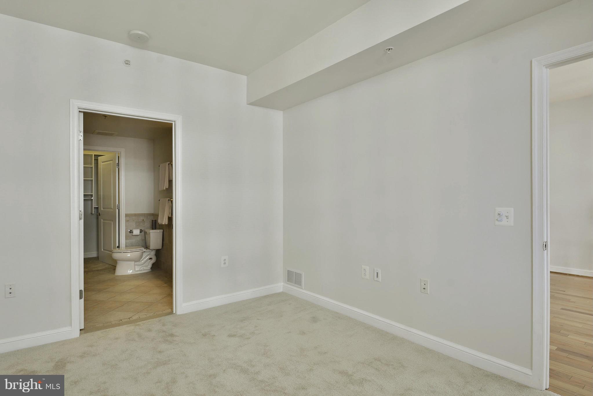 11990 Market Street, Unit 1204 Reston, VA 20190 - Photo 21 of 30 a view of an empty room and a livingroom