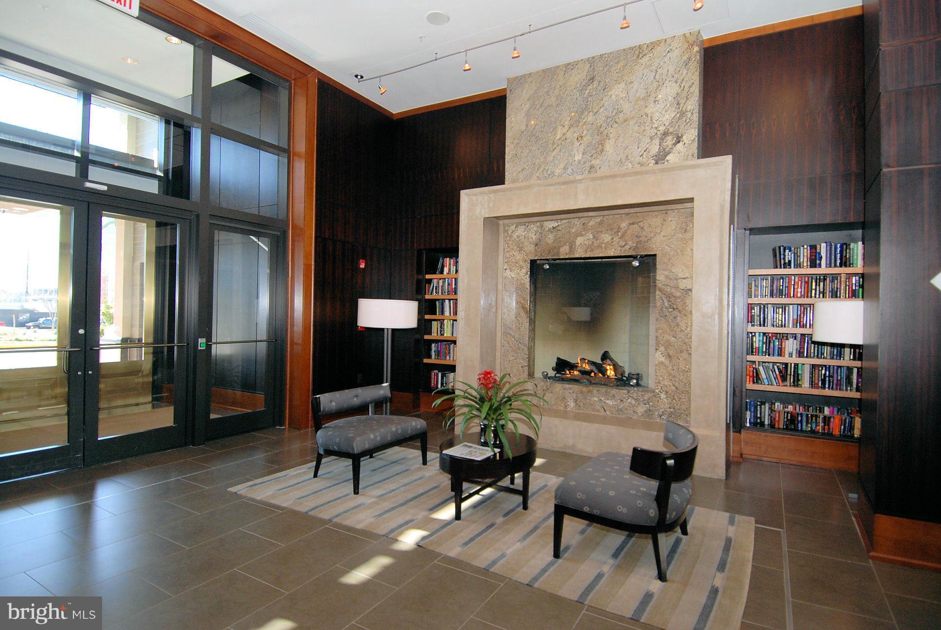 11990 Market Street, Unit 1204 Reston, VA 20190 - Photo 4 of 30 a living room with furniture and a fireplace