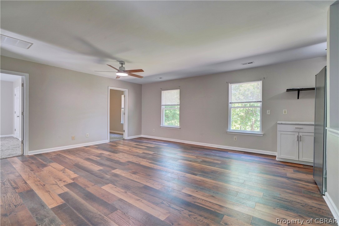 8269 Ark Road Gloucester, VA 23061 - Photo 9 of 33 Unfurnished living room with ceiling fan and dark hardwood / wood-style flooring