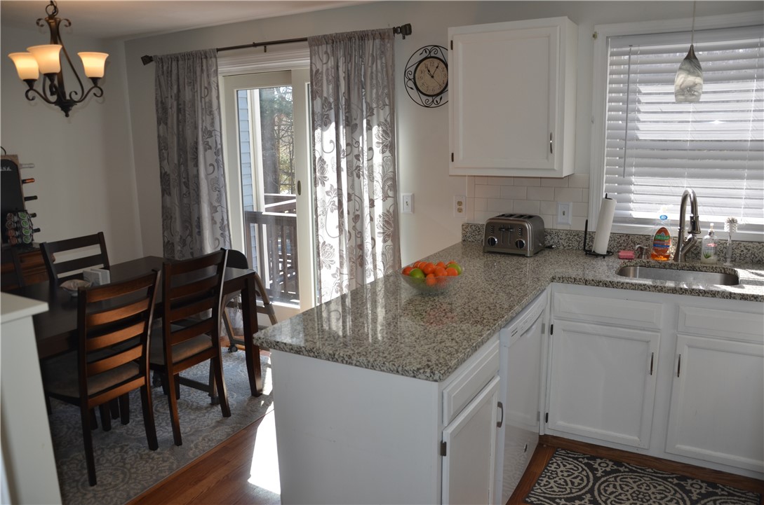 8 Sandy Lane Burrillville, RI 02830 - Photo 13 of 35 The peninsula which separates the kitchen & dining area affords the perfect spot for food prep or serving with convenient access to the dishwasher.