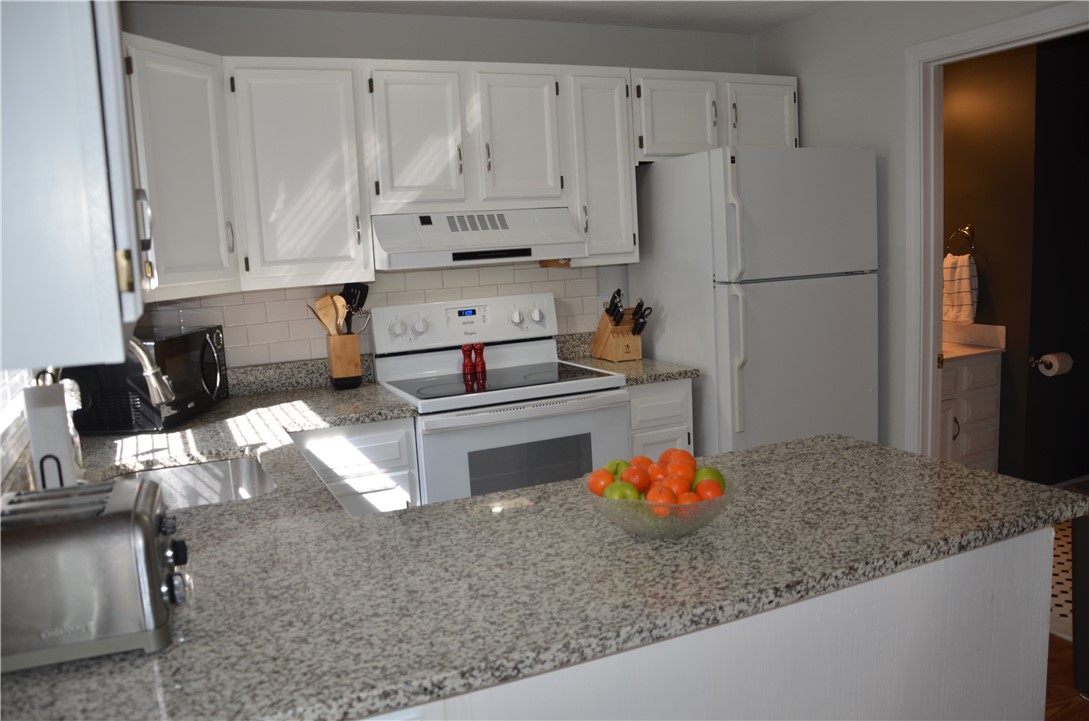 8 Sandy Lane Burrillville, RI 02830 - Photo 9 of 35 Stone countertops and classic subway tile are newer features in the kitchen. Let's go check out the lavette and laundry...