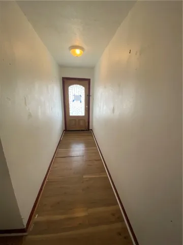 a view of hallway with wooden floor