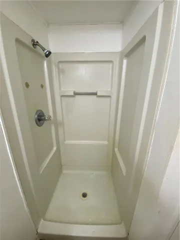 a bathroom with a glass door shower