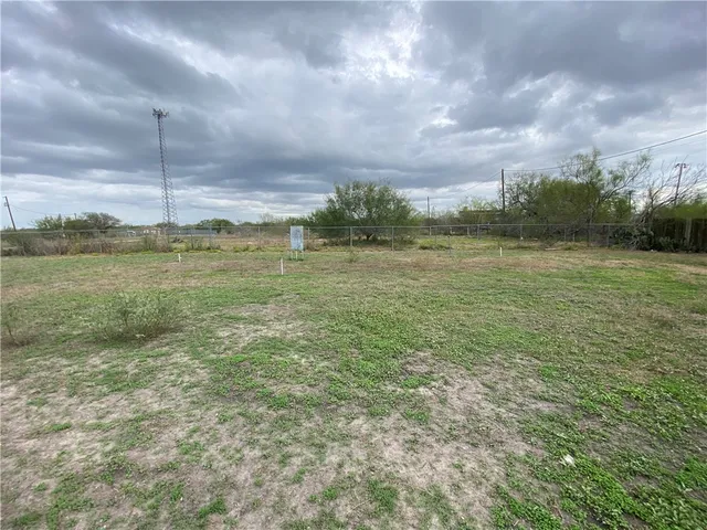 a view of a field with an ocean