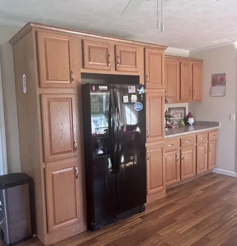 a kitchen with stainless steel appliances granite countertop a refrigerator and cabinets