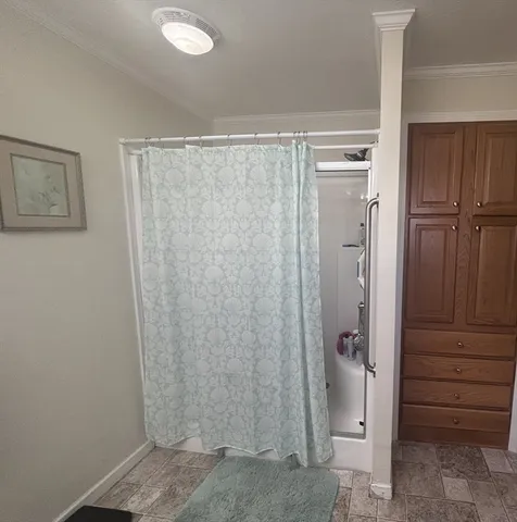 a bathroom with a shower and a sink