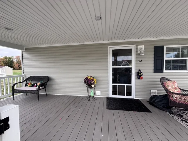 a view of a house with wooden deck