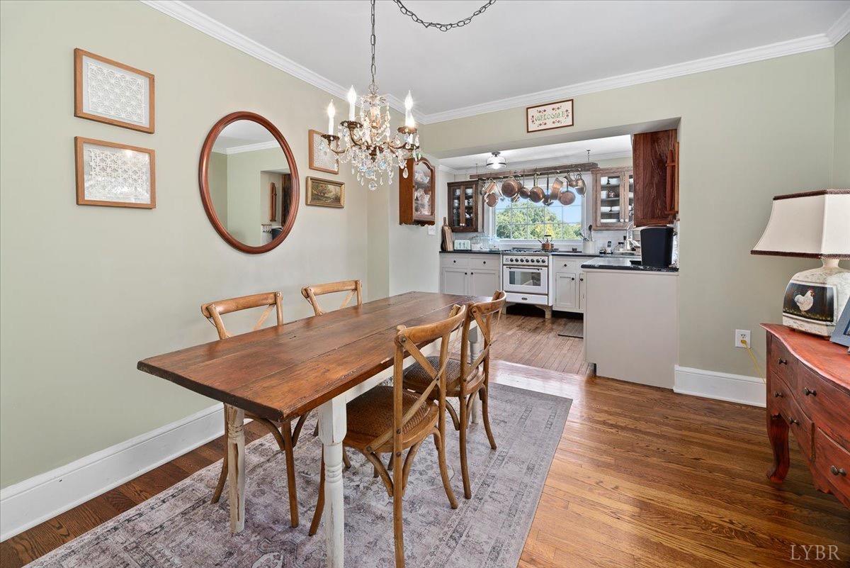 380 St Marys Road Amherst, VA 24521 - Photo 15 of 20 a view of a dining room with furniture a chandelier and wooden floor