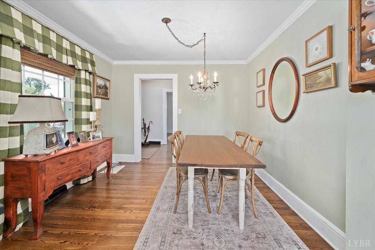 380 St Marys Road Amherst, VA 24521 - Photo 16 of 20 a dining room with wooden floor a glass table and chairs