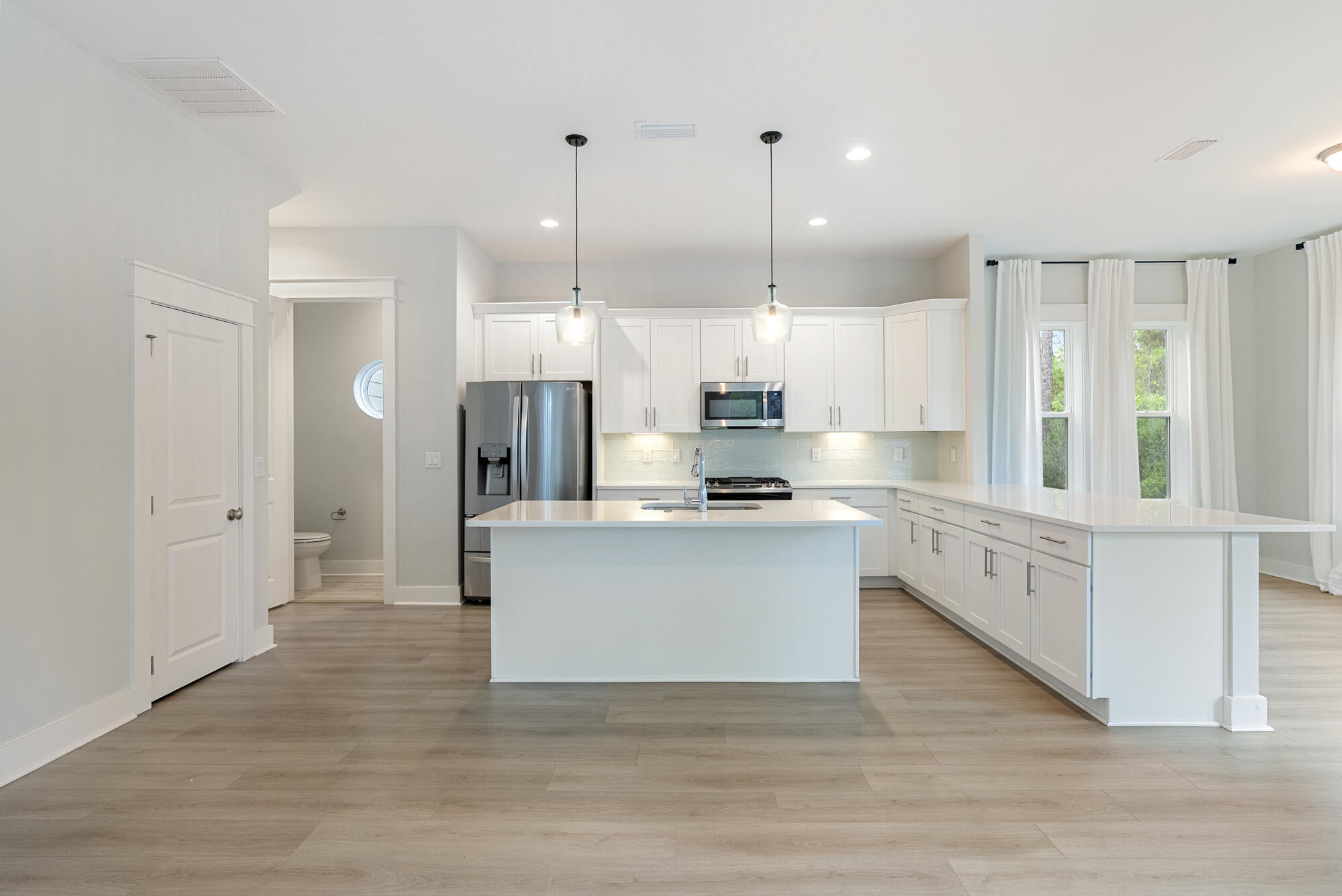 248 Euvino Way Santa Rosa Beach, FL 32459 - Photo 14 of 56 a large white kitchen with stainless steel appliances