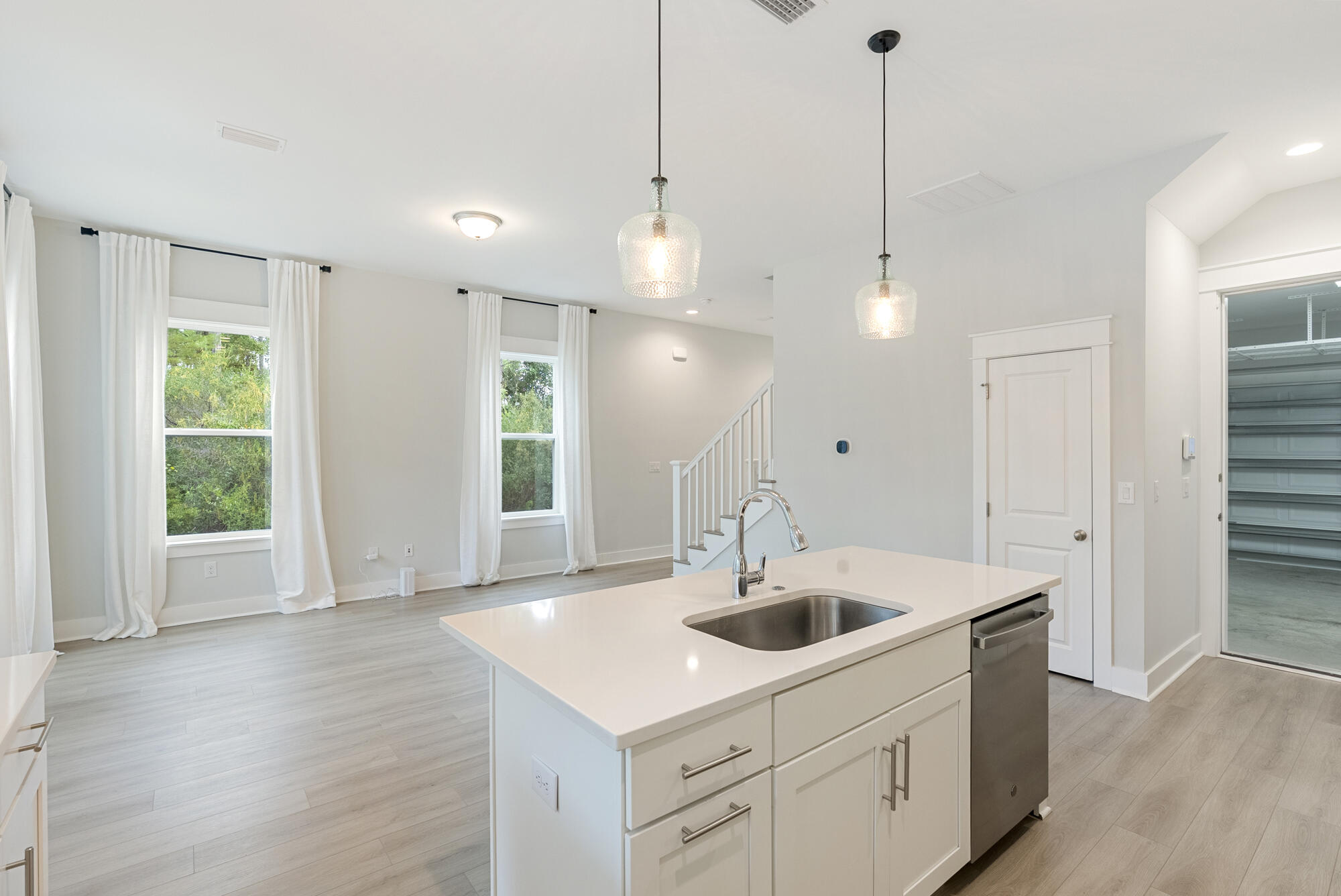 248 Euvino Way Santa Rosa Beach, FL 32459 - Photo 15 of 56 a kitchen with stainless steel appliances a sink a wooden floor and a large window