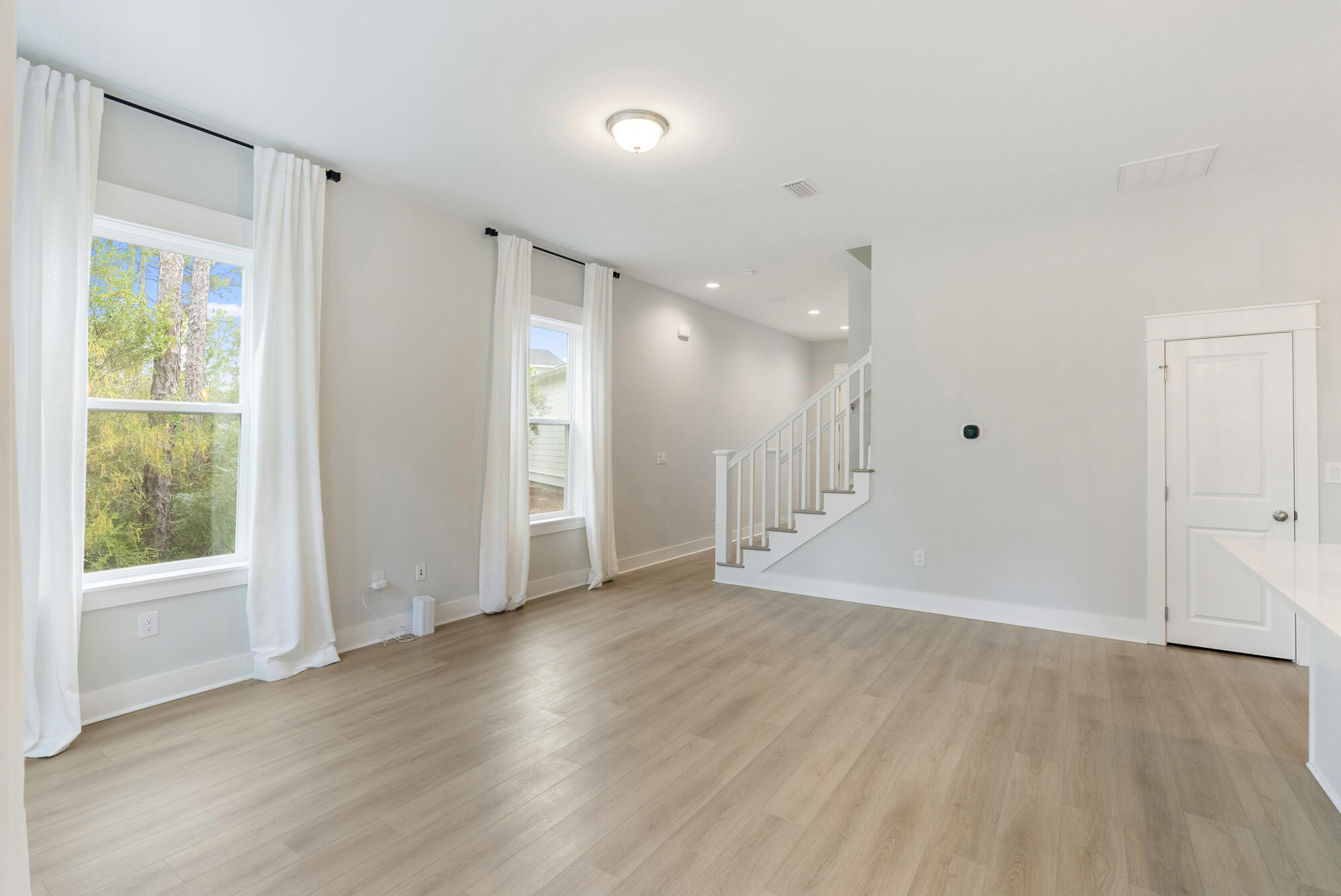 248 Euvino Way Santa Rosa Beach, FL 32459 - Photo 17 of 56 a view of an empty room with wooden floor and a window