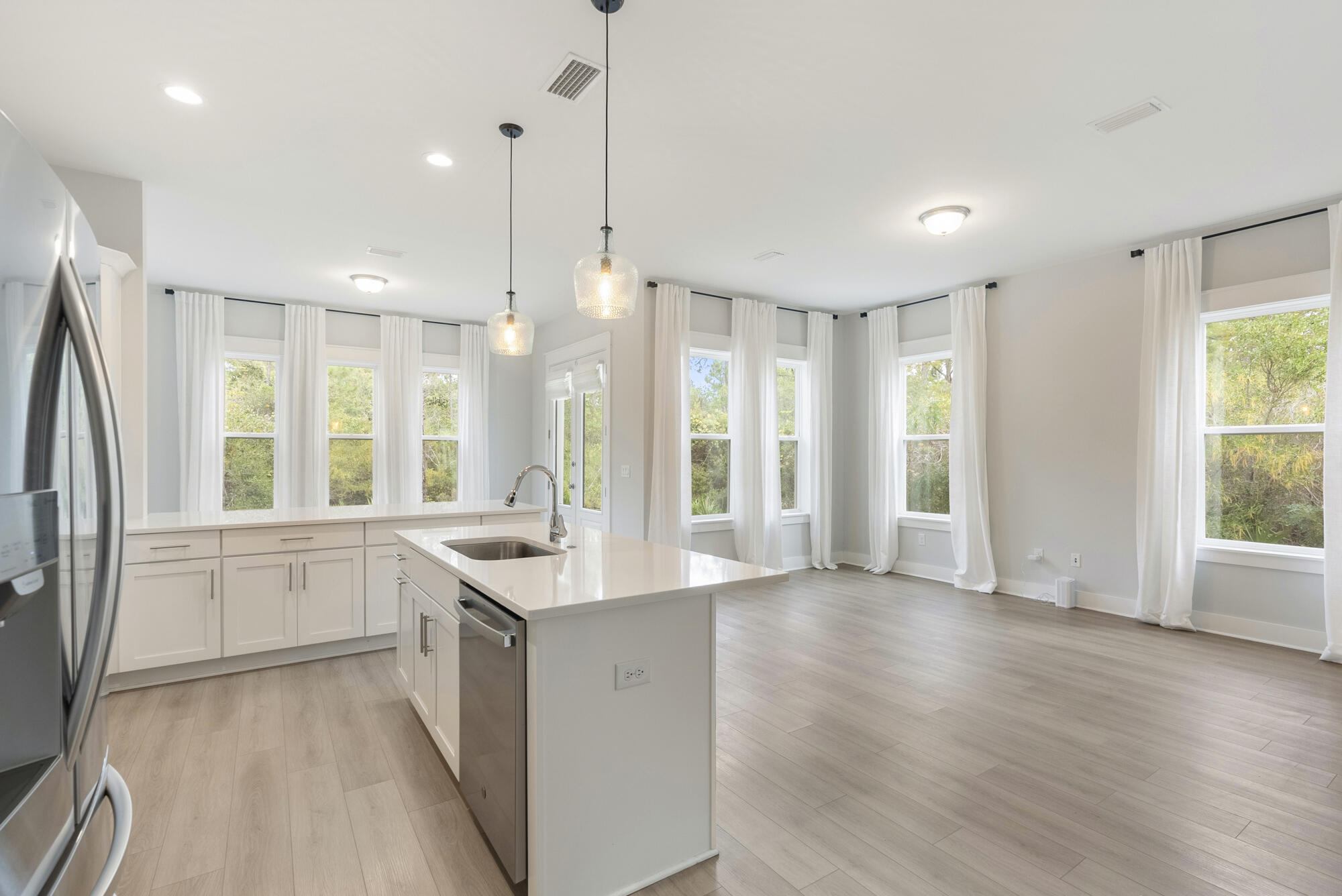 248 Euvino Way Santa Rosa Beach, FL 32459 - Photo 20 of 56 a kitchen with stainless steel appliances granite countertop a refrigerator a sink and white cabinets