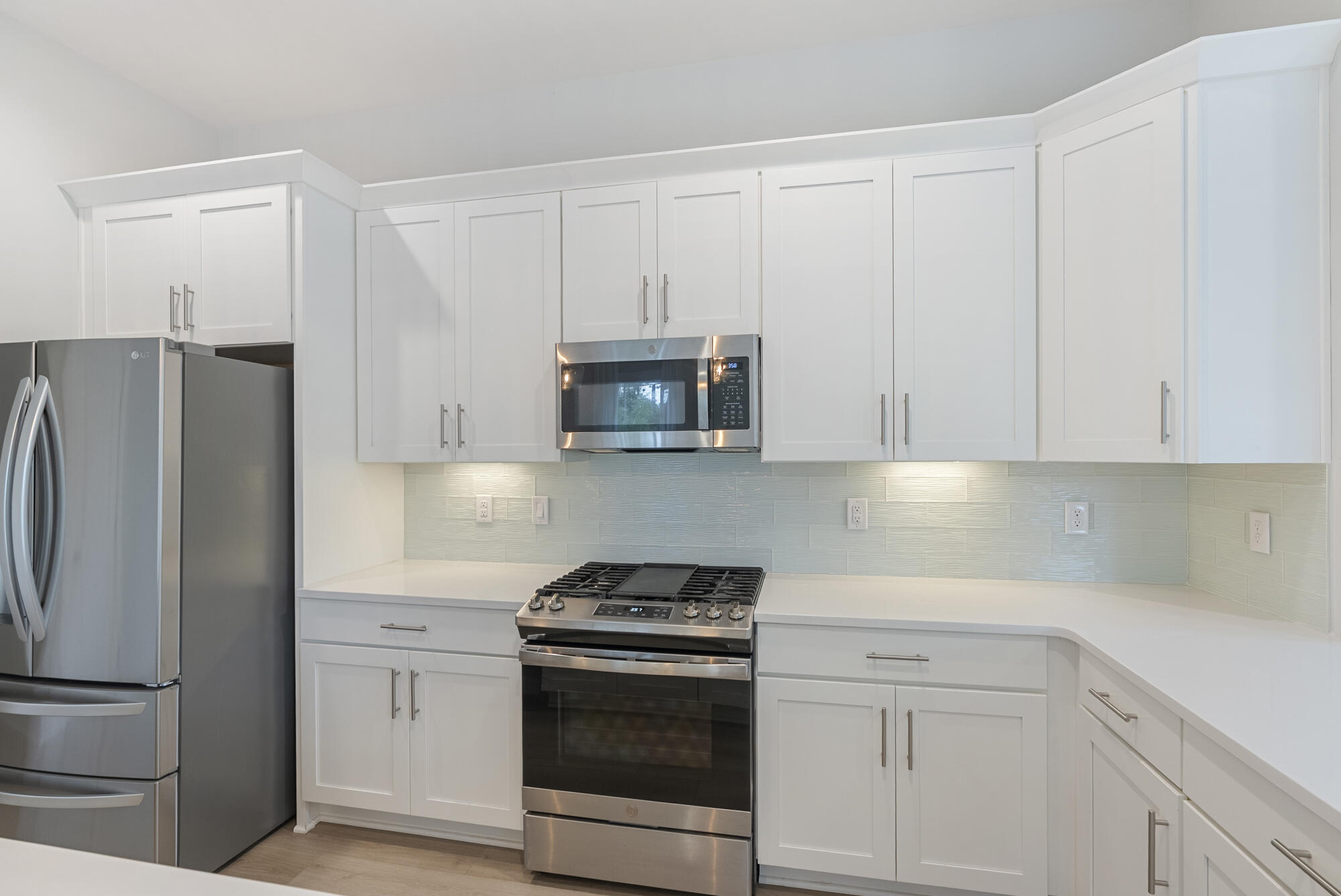 248 Euvino Way Santa Rosa Beach, FL 32459 - Photo 21 of 56 a kitchen with white cabinets and stainless steel appliances