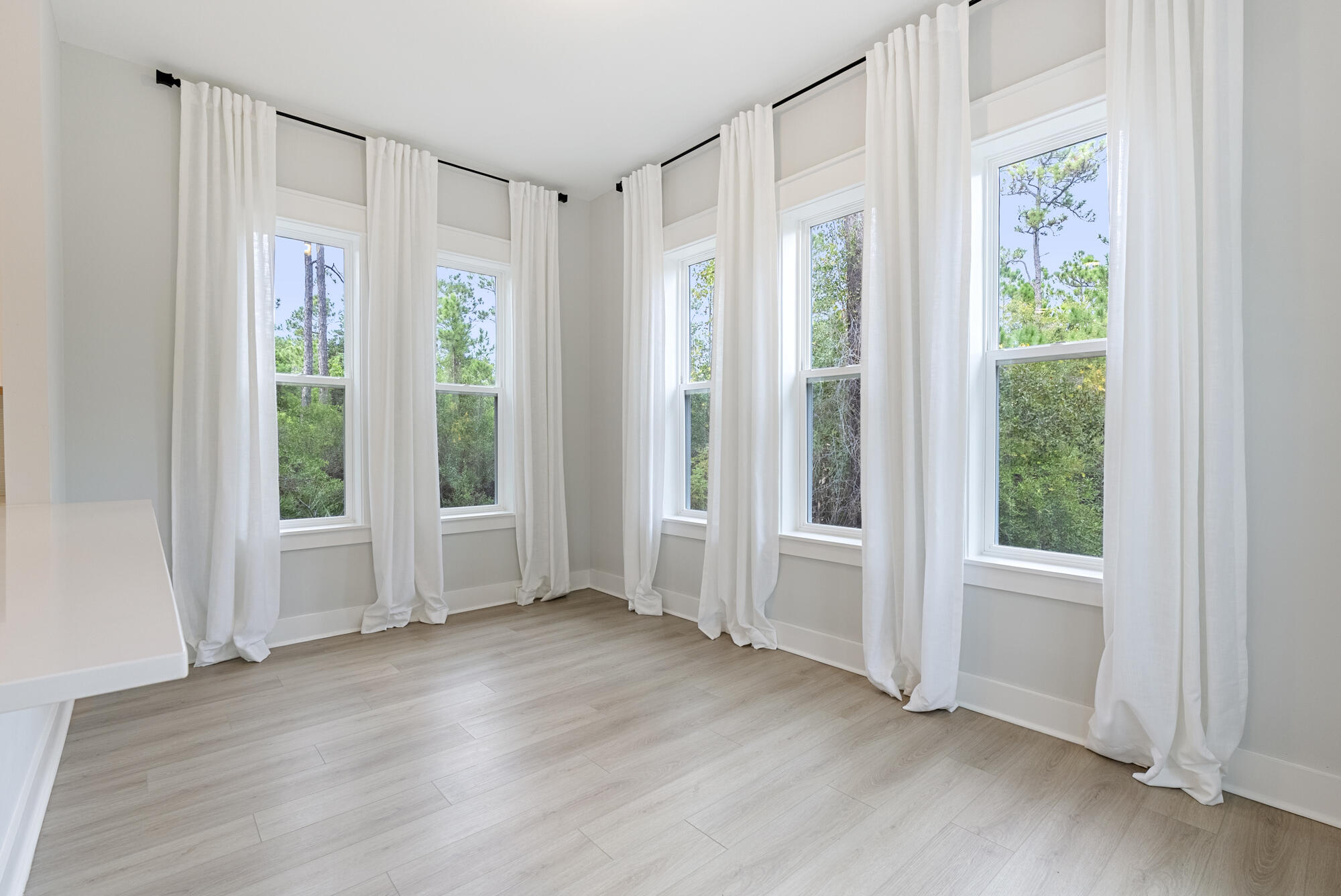 248 Euvino Way Santa Rosa Beach, FL 32459 - Photo 22 of 56 a view of an empty room with wooden floor and a window