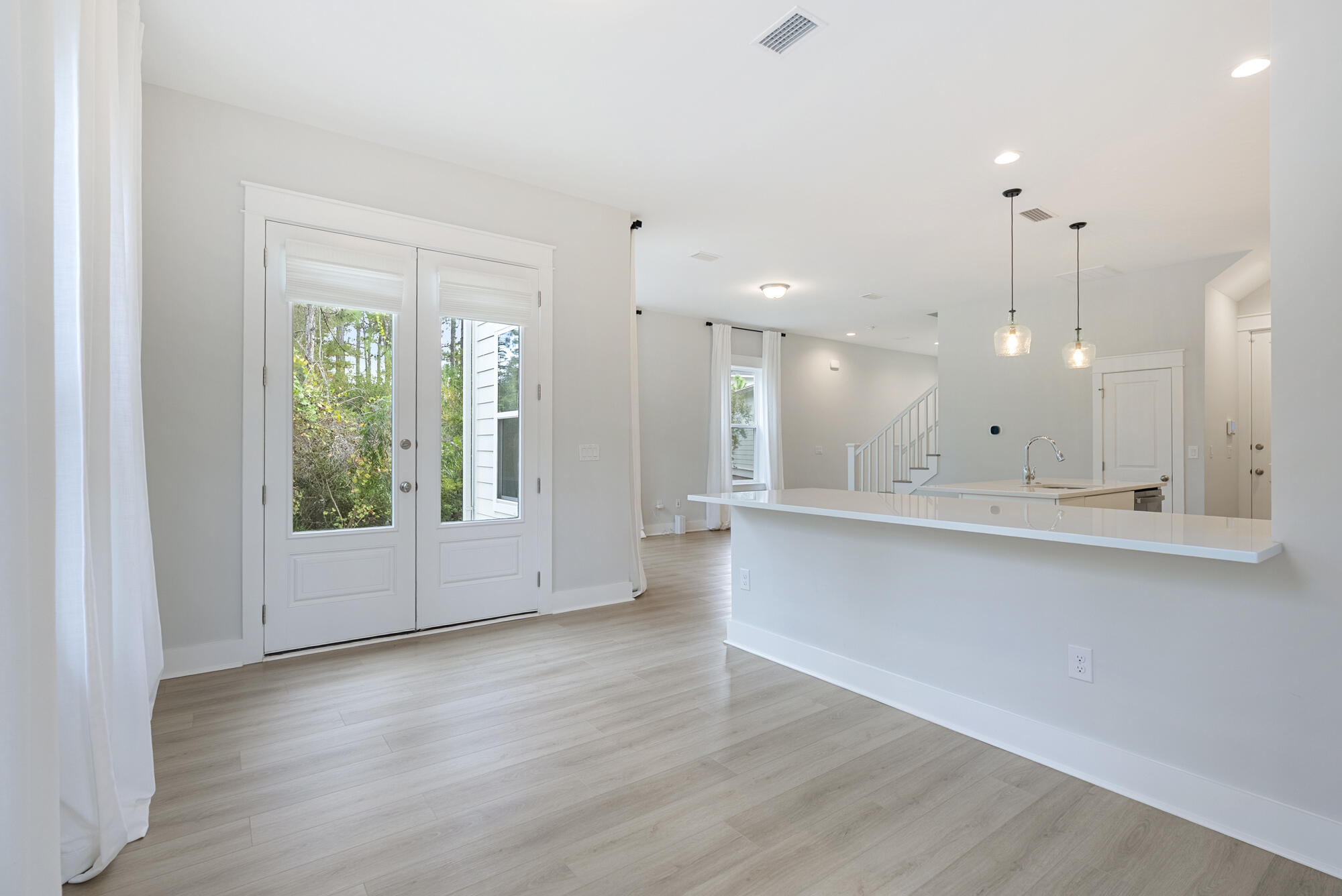 248 Euvino Way Santa Rosa Beach, FL 32459 - Photo 23 of 56 a view of an empty room with window and wooden floor