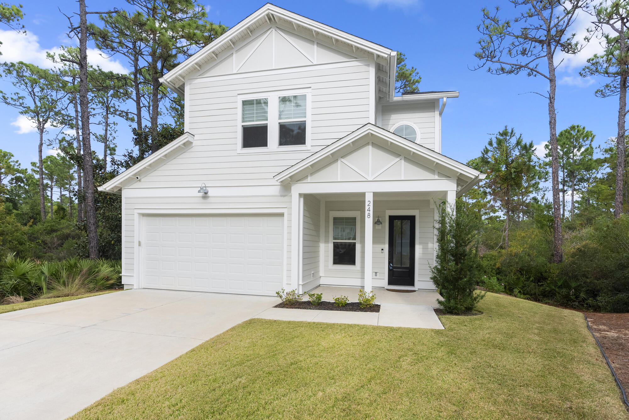 248 Euvino Way Santa Rosa Beach, FL 32459 - Photo 38 of 56 a front view of a house with a yard and garage