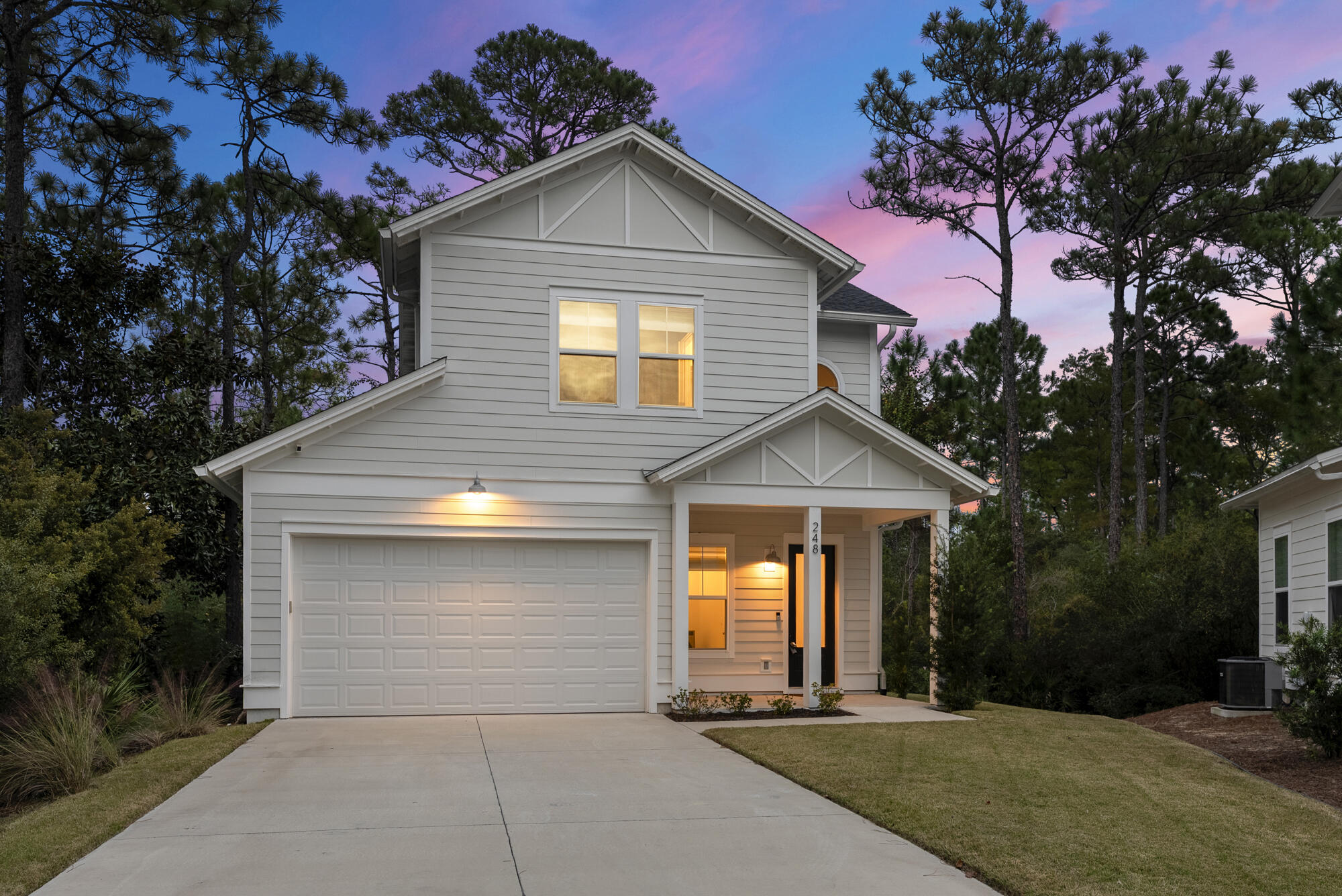 248 Euvino Way Santa Rosa Beach, FL 32459 - Photo 48 of 56 a front view of a house with a yard and garage