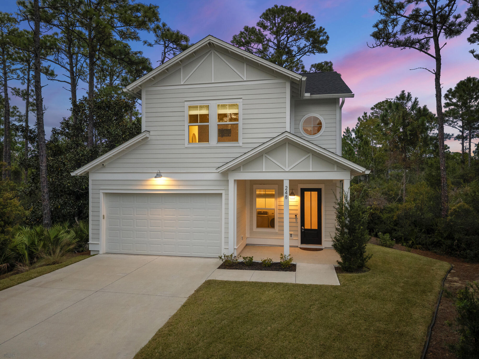 248 Euvino Way Santa Rosa Beach, FL 32459 - Photo 51 of 56 a front view of a house with a yard and garage