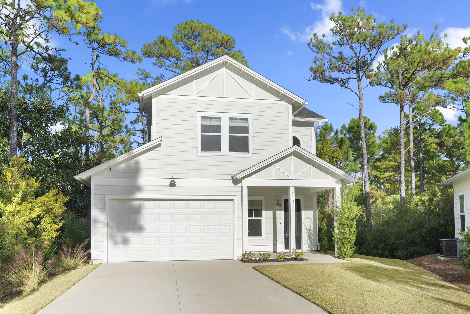 248 Euvino Way Santa Rosa Beach, FL 32459 - Photo 6 of 56 a front view of a house with a yard and garage