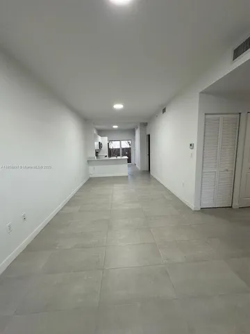 a kitchen with a sink a microwave and cabinets