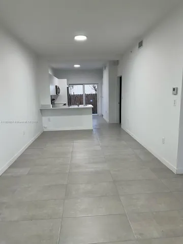 a large kitchen with cabinets and steel stainless steel appliances