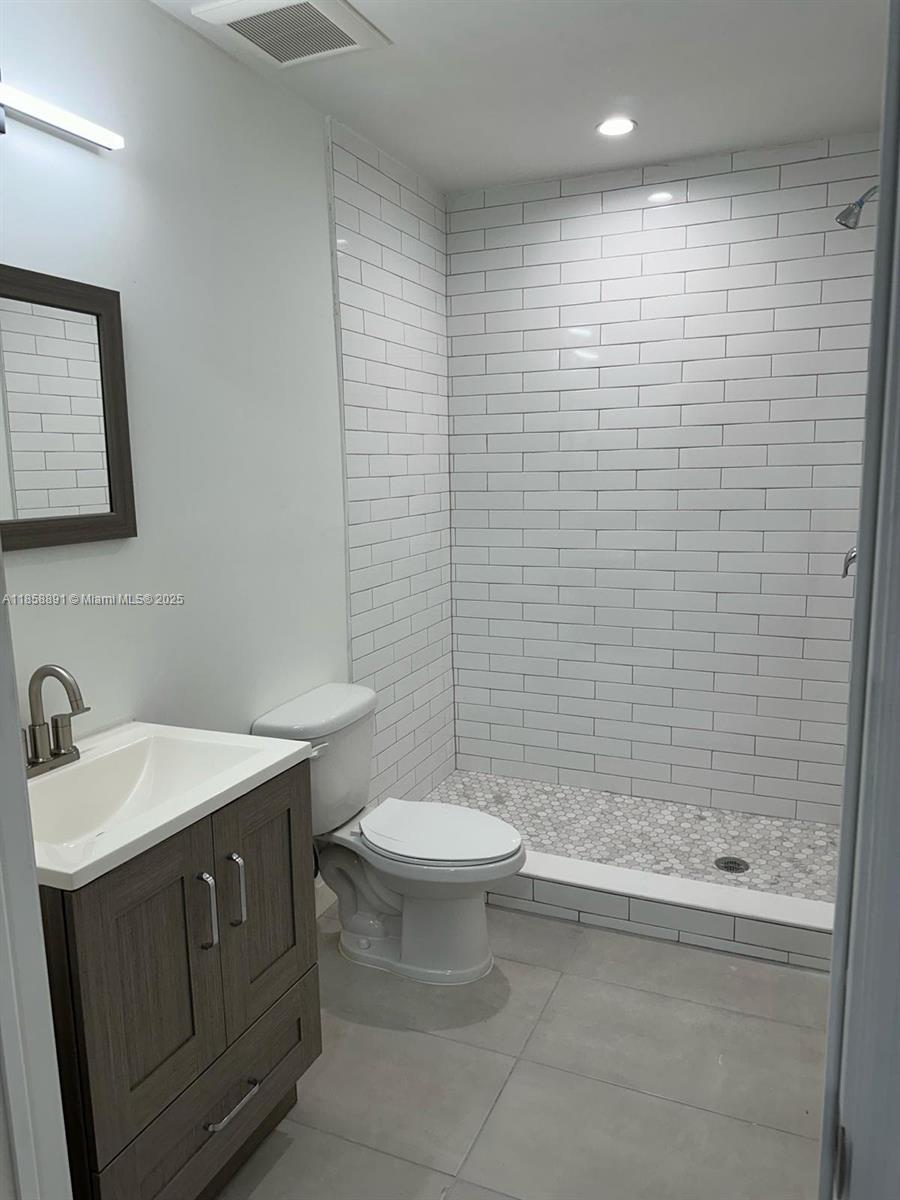 541 Southwest 2nd Court, Unit 5 Pompano Beach, FL 33060 - Photo 17 of 20 a bathroom with a sink a toilet and shower