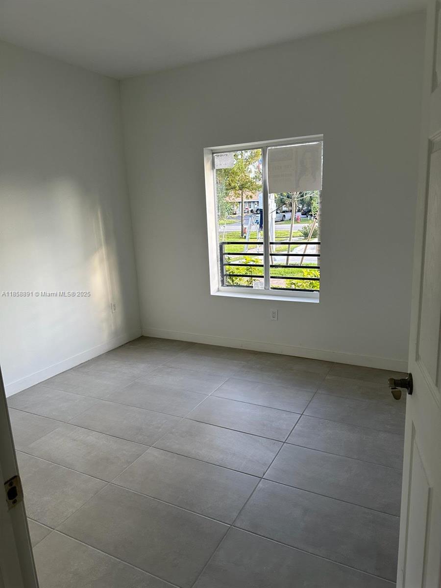 541 Southwest 2nd Court, Unit 5 Pompano Beach, FL 33060 - Photo 5 of 20 a view of an empty room with a window