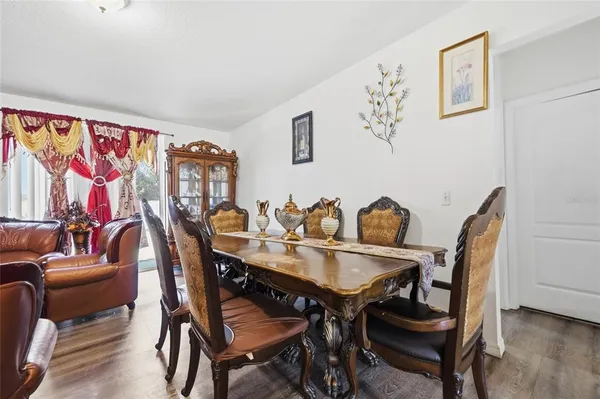a view of a dining room with furniture and wooden floor