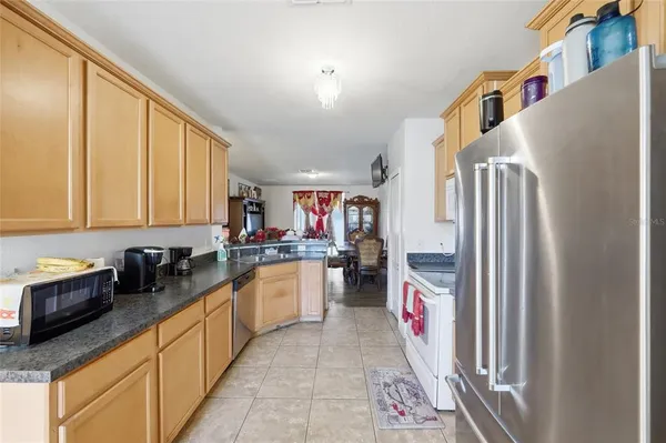 a kitchen with a refrigerator and a sink