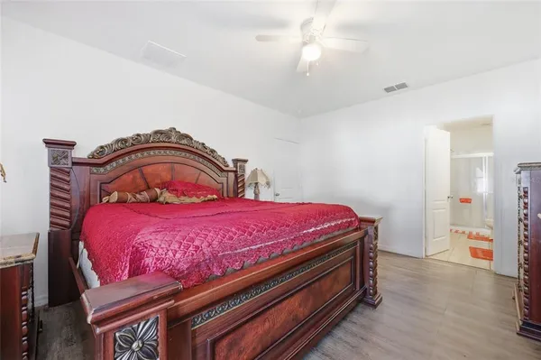 a bedroom with a bed and a dresser