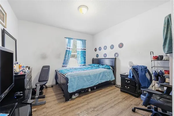 a bedroom with a bed and a desk