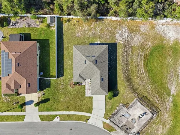 an aerial view of a house with a yard