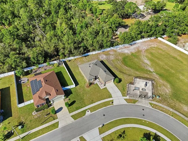 an aerial view of a house with a swimming pool