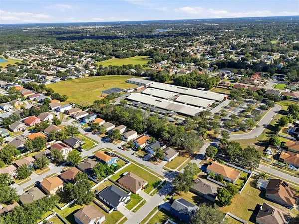 an aerial view of residential houses with outdoor space