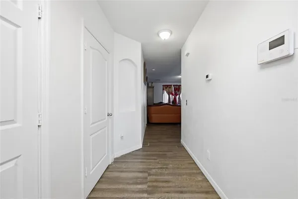 a view of a hallway with a livingroom and a hallway