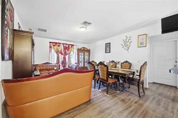a view of a dining room with furniture window and wooden floor
