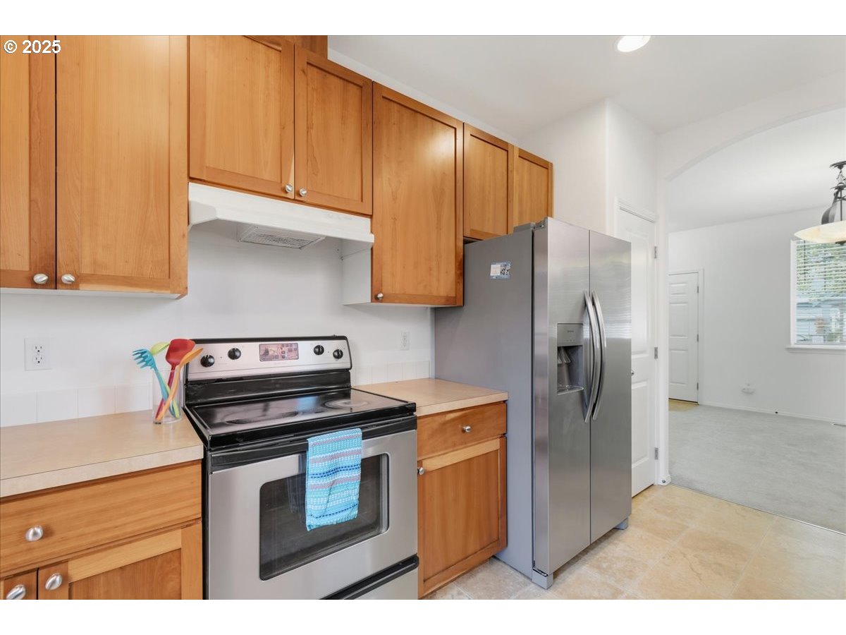 3527 Southeast 197th Avenue Camas, WA 98607 - Photo 15 of 38 a kitchen with stainless steel appliances granite countertop a refrigerator a stove and a sink