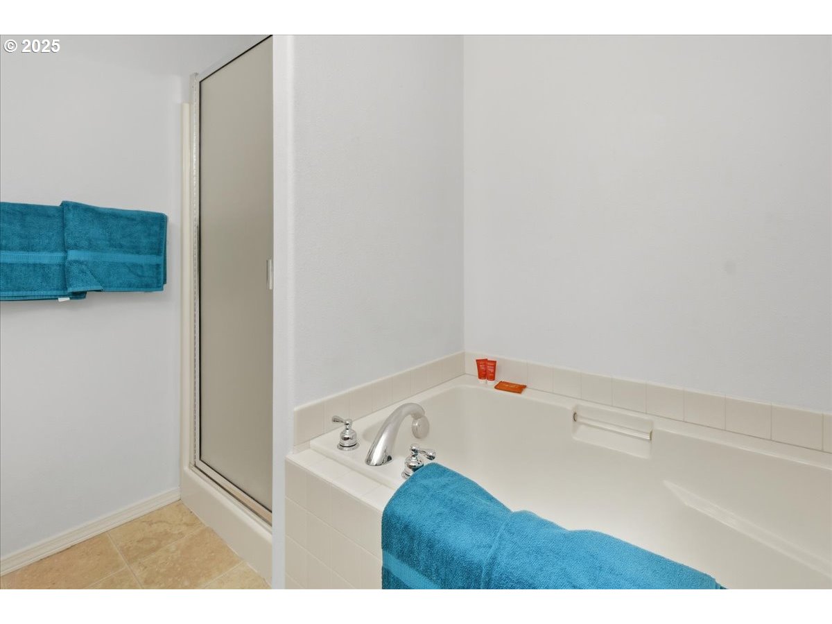 3527 Southeast 197th Avenue Camas, WA 98607 - Photo 21 of 38 a bathroom with a bathtub and a shower