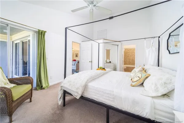 a bedroom with a bed and large mirror