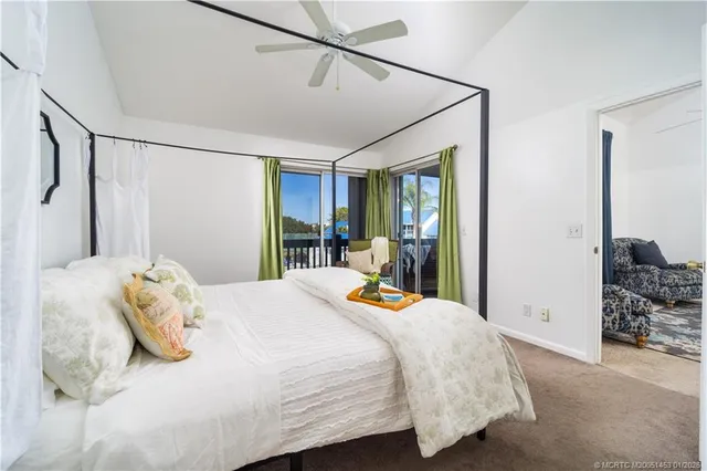 a view of a swimming pool with a lawn chairs and a dining space
