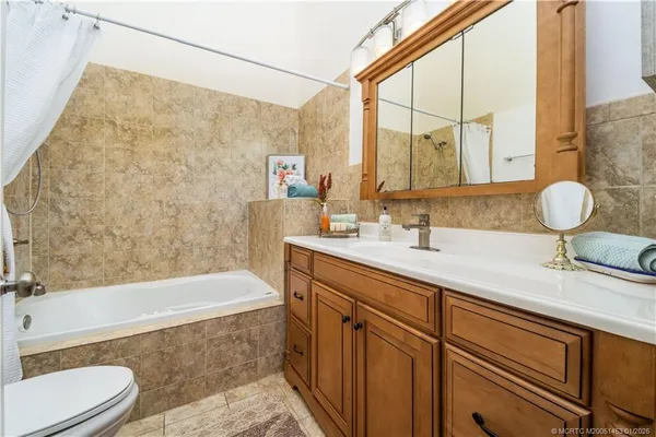 a bathroom with a bathtub and a toilet