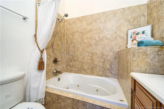 a view of a house with a small yard and potted plants